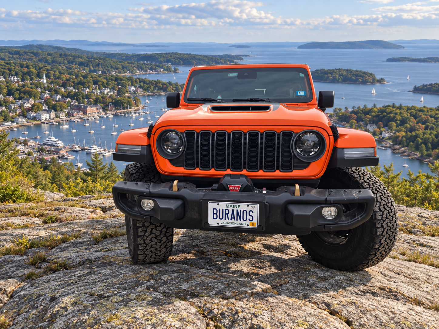 Orange Burano’s Jeep with Camden Harbor and Penobscot Bay in the background